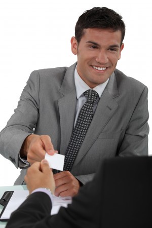 Man handing over his business card to a potential client